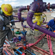 Workers tend to a well head during a hydraulic fracturing operation outside Rifle, in western Colorado. A comprehensive new report links the practice to contaminated drinking water. (Image: AP)